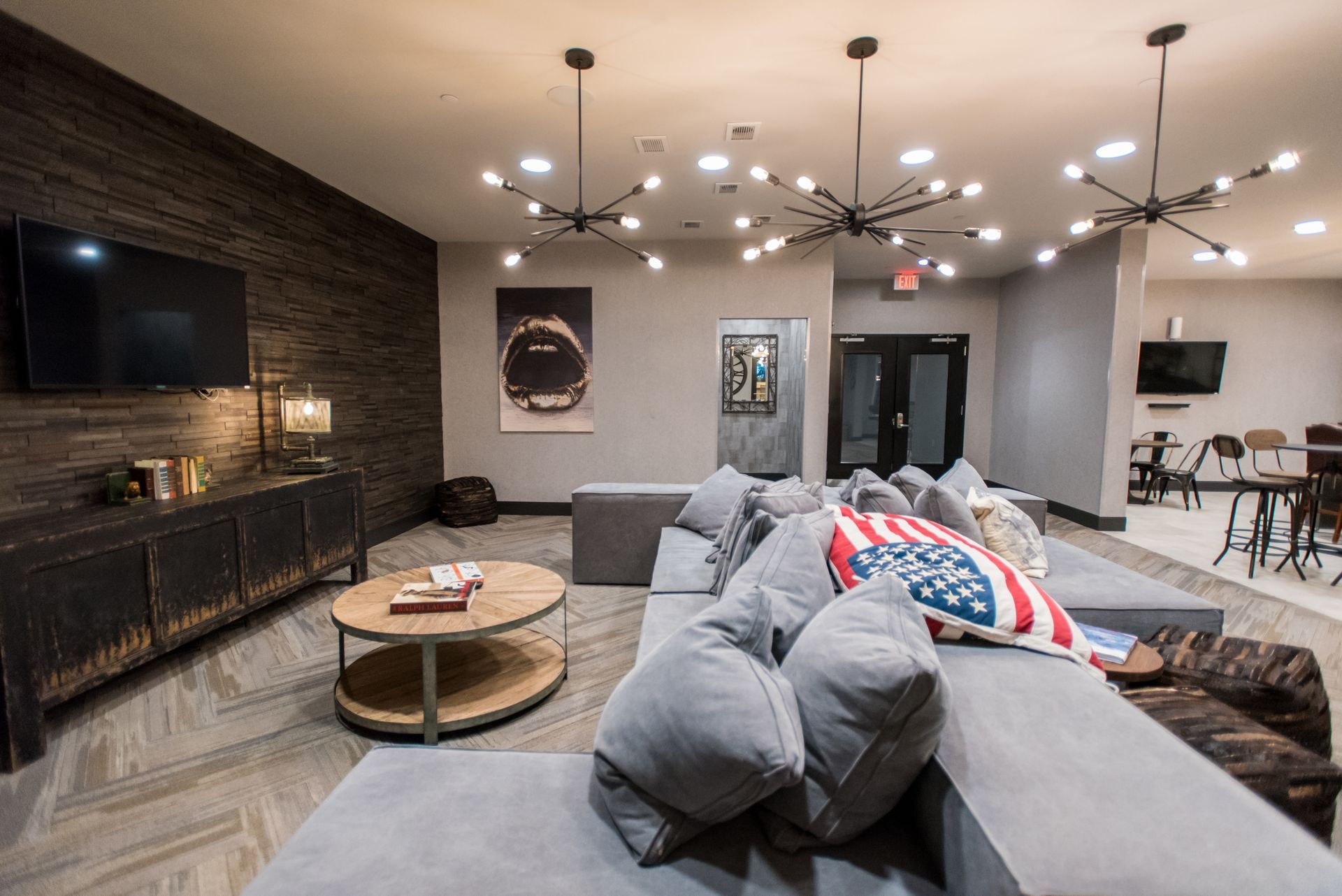 A living room with a couch , coffee table , television and fireplace.