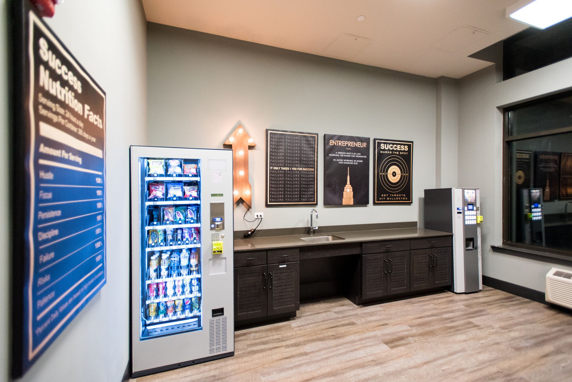 A room with a vending machine and a sign on the wall.