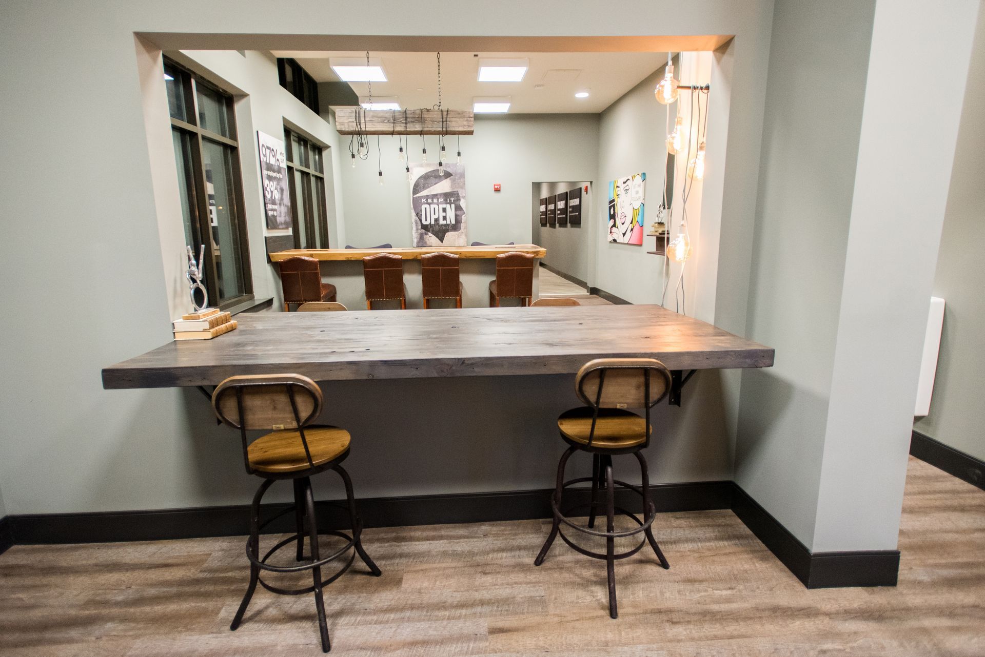 A room with a table and chairs and a pool table.