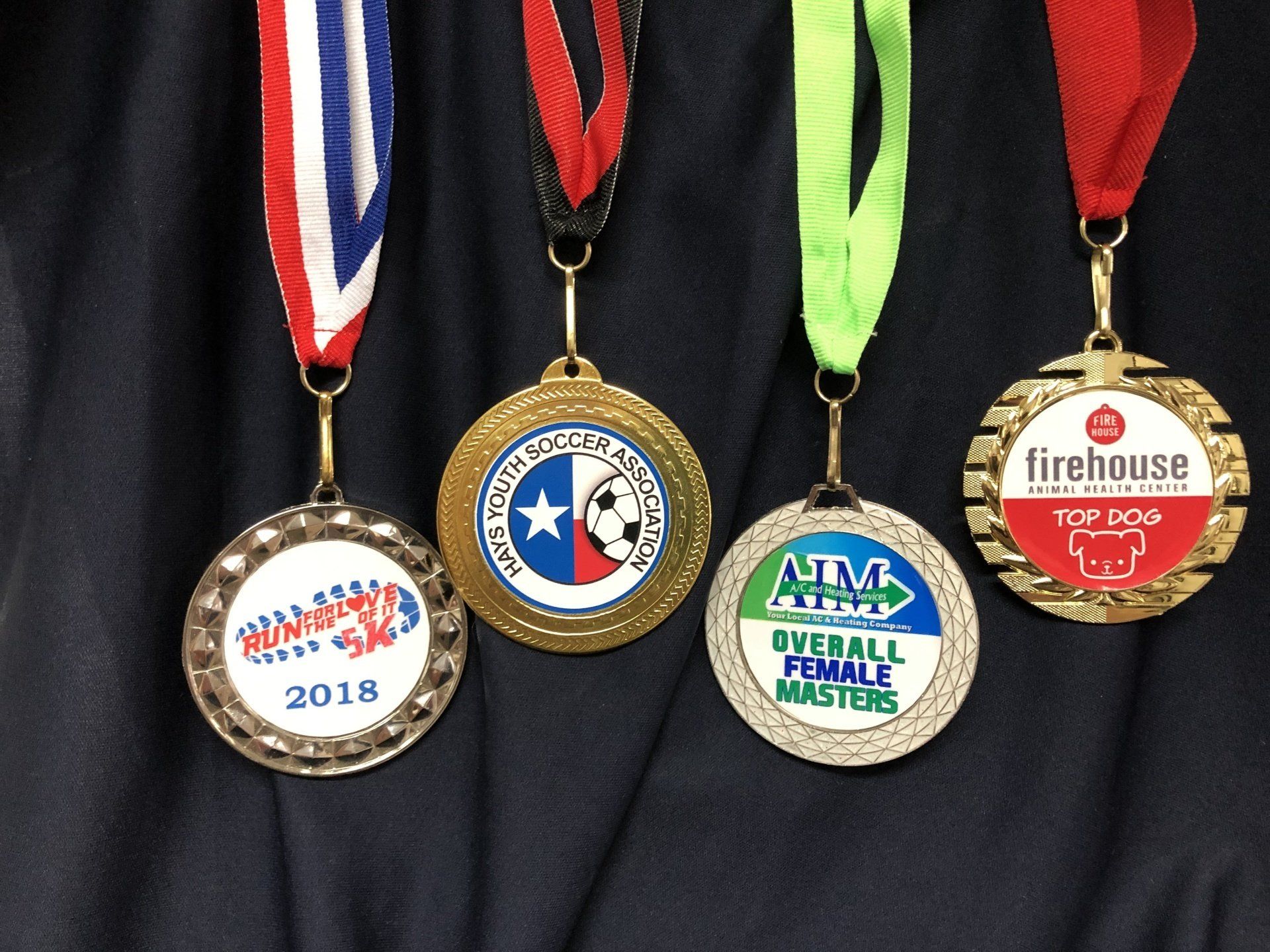 Medals from many shapes and subjects - Football, cheer, academics.  custom  printed ribbons