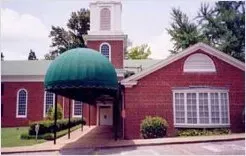 Building with Front Half Barrel Green Awning — Decatur, AL — Evans Awnings