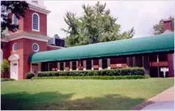 Brick Building with Half Barrel Green Awning — Decatur, AL — Evans Awnings