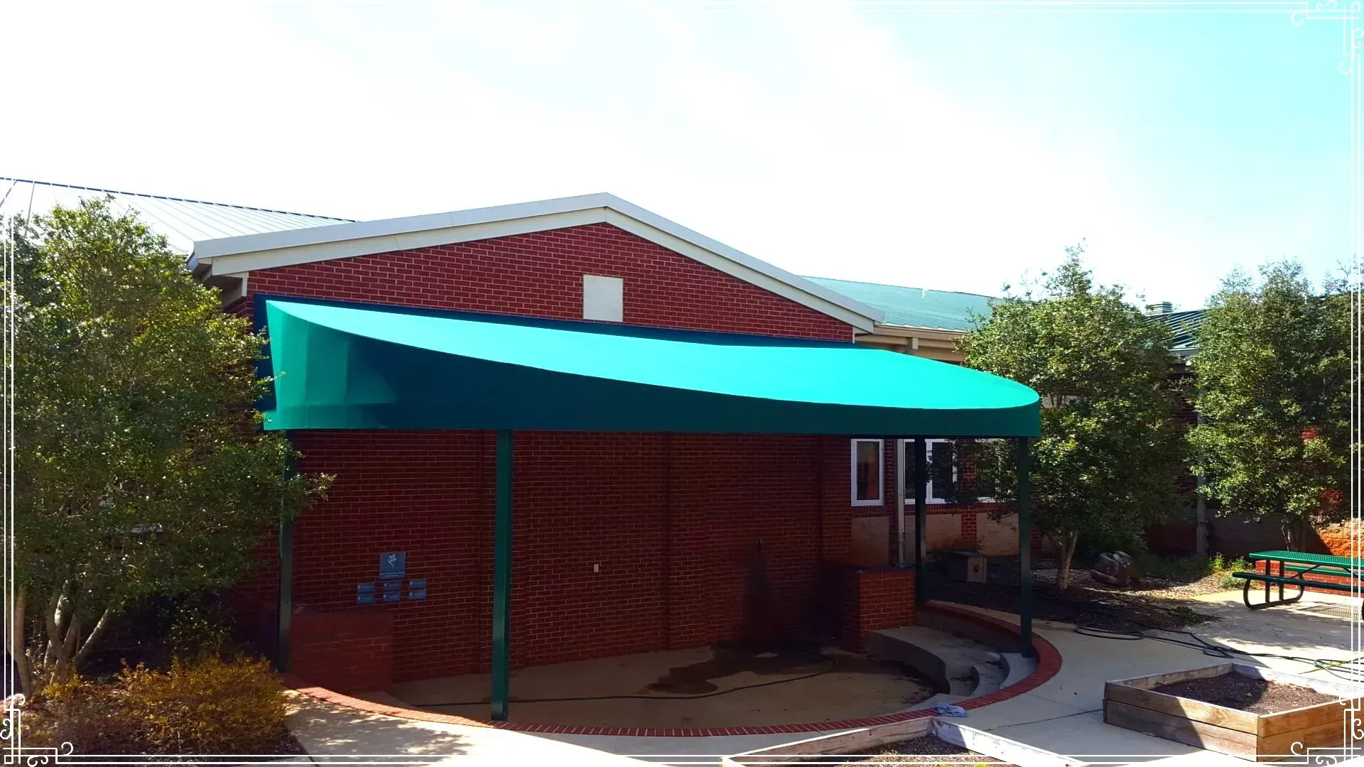 Brick Building with Green Awning — Decatur, AL — Evans Awnings