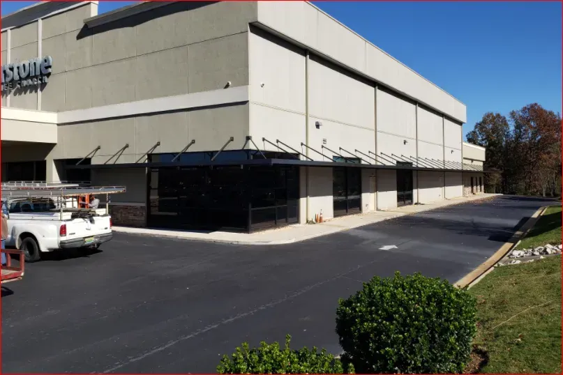 Store Building with Black Overhead Rod Canopy — Decatur, AL — Evans Awnings