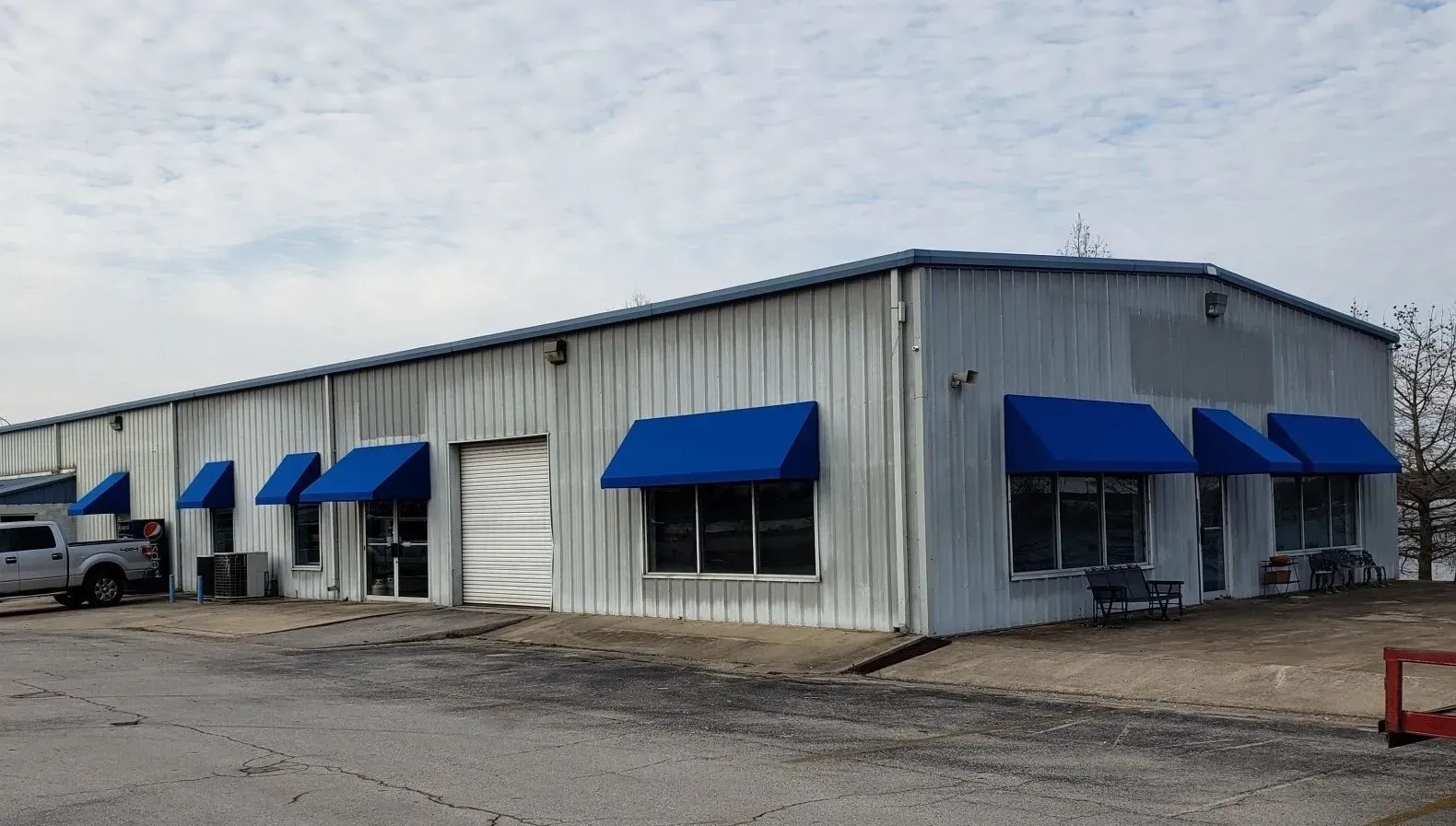 Blue Slope Awnings Over the Door & Windows of a Building — Decatur, AL — Evans Awnings