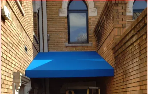 Blue Awning on the Side of a Brick Building — Decatur, AL — Evans Awnings