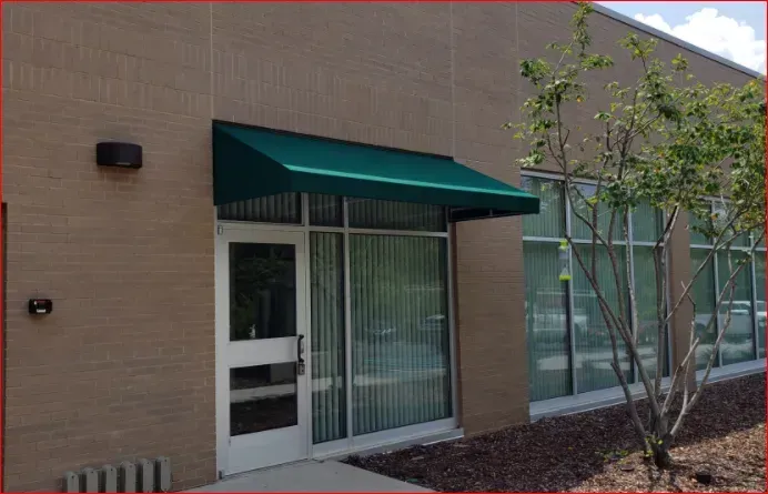 Commercial Building with Green Awning Over the Door — Decatur, AL — Evans Awnings