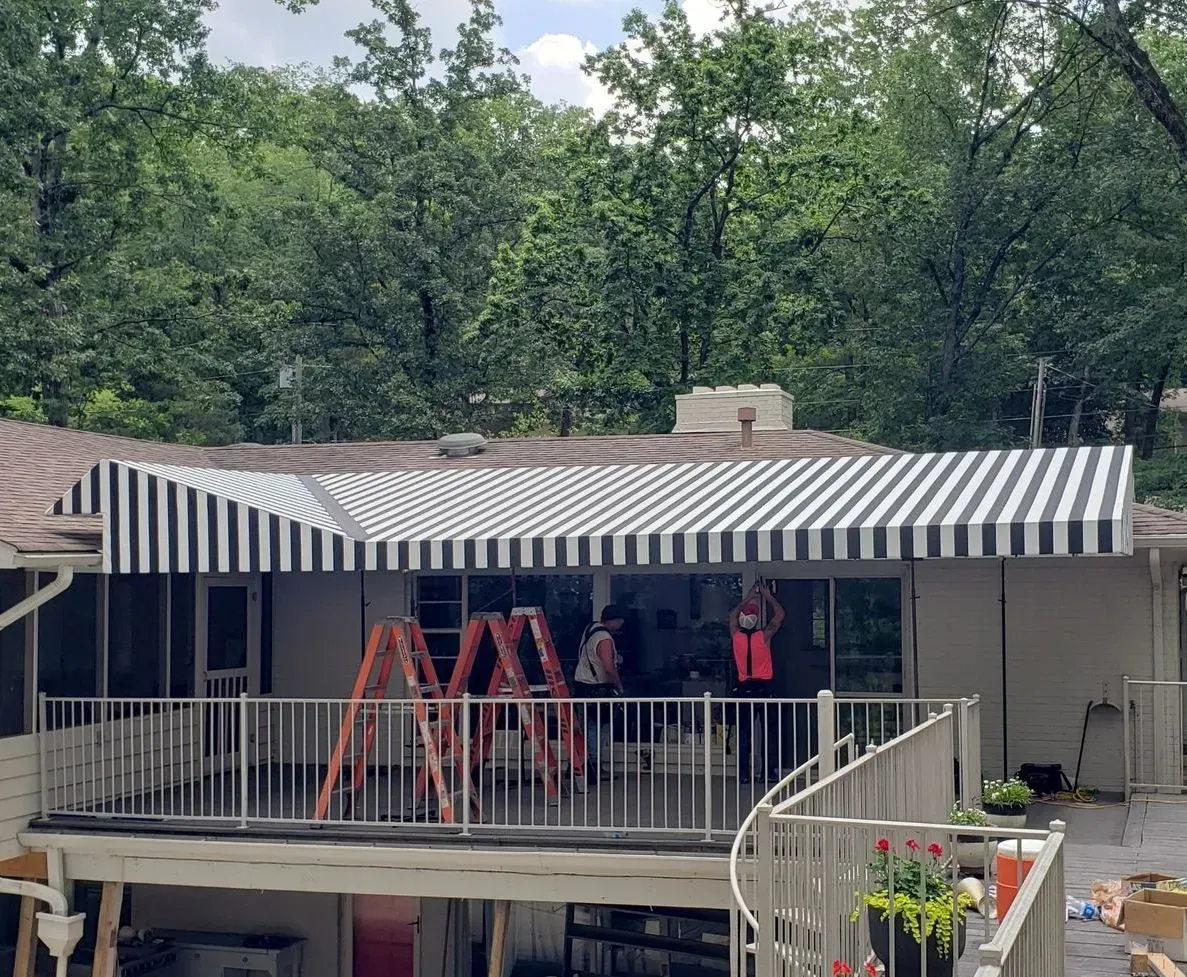Striped Awning is Being Installed on a Deck — Decatur, AL — Evans Awnings