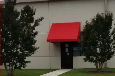 White Building with Red Awning Over the Door — Decatur, AL — Evans Awnings