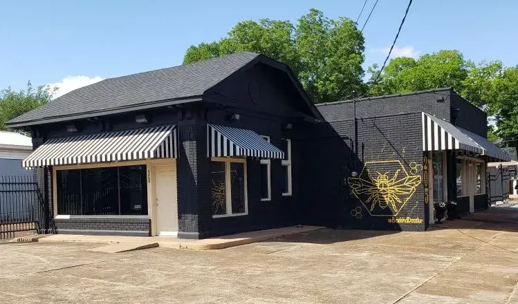 Black Brick Building with Stripe Slope — Decatur, AL — Evans Awnings