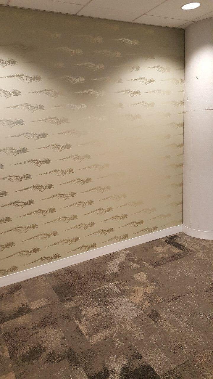 A room with a carpeted floor and a wall with writing on it.