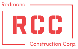 The logo for redmond construction corp. is red and white.