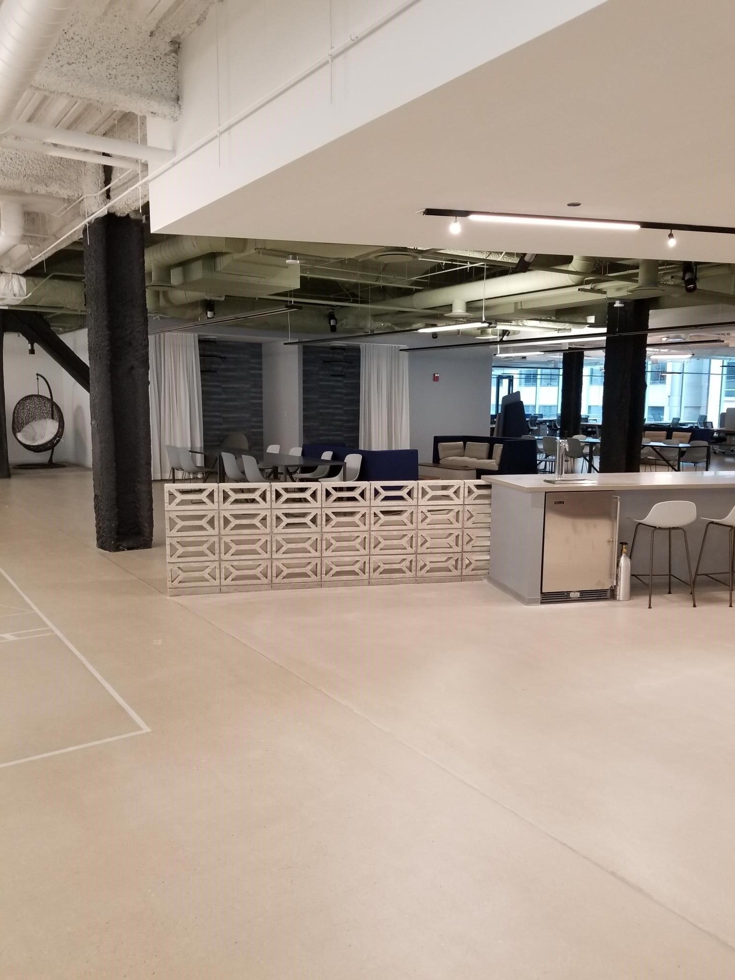 A large room with a table and chairs in it