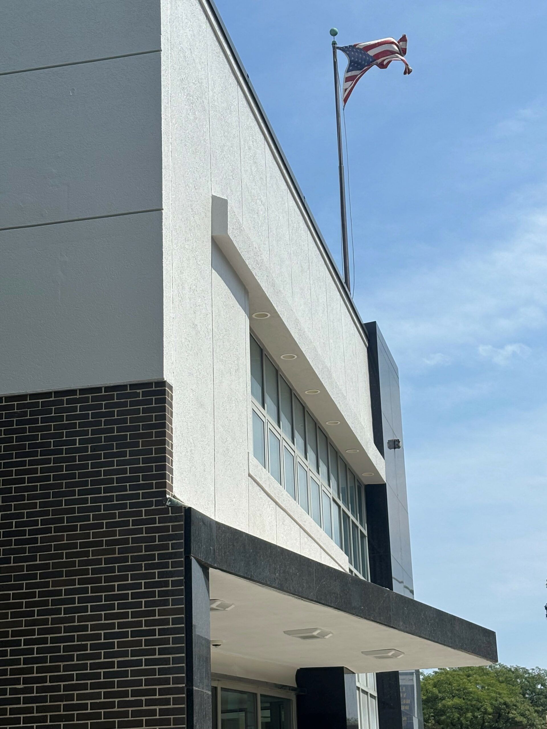 An american flag is flying on top of a building