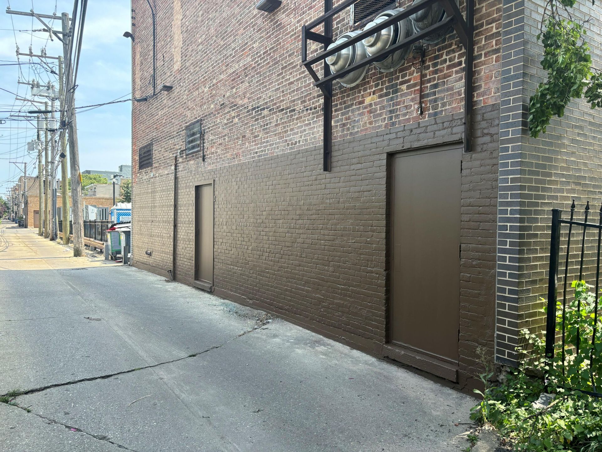 A brick building with a door on the side of it.