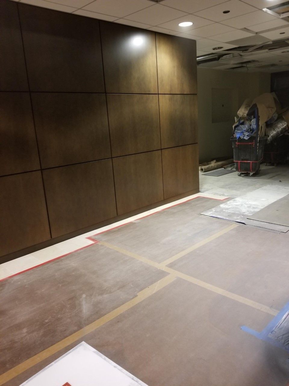 A room with a wooden wall and a concrete floor.