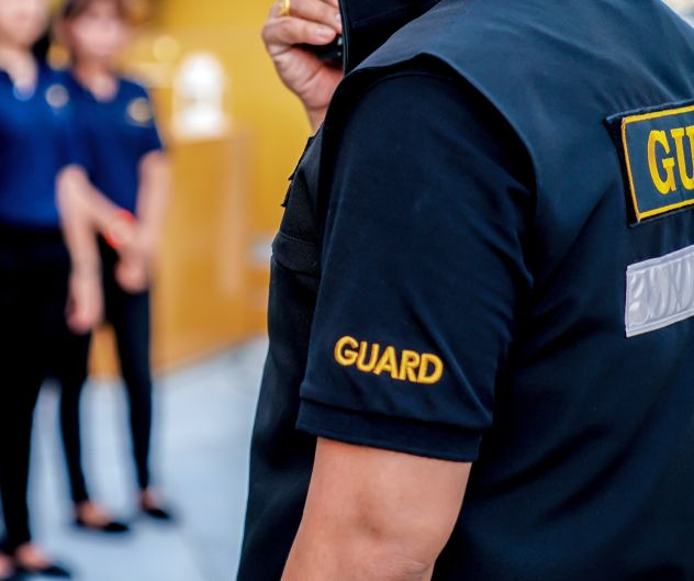A Machine is Embroidery a Letter a on a Blue Cloth — Tableland Workwear In Tolga, QLD