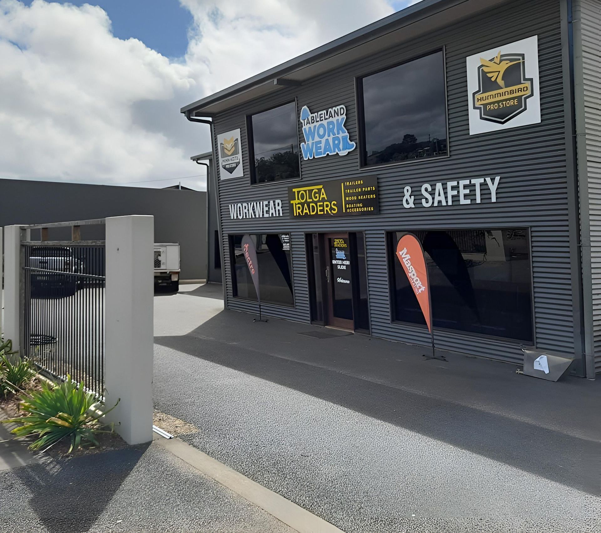 An Ambulance Is Parked In Front Of A Building — Tableland Workwear In Tolga, QLD