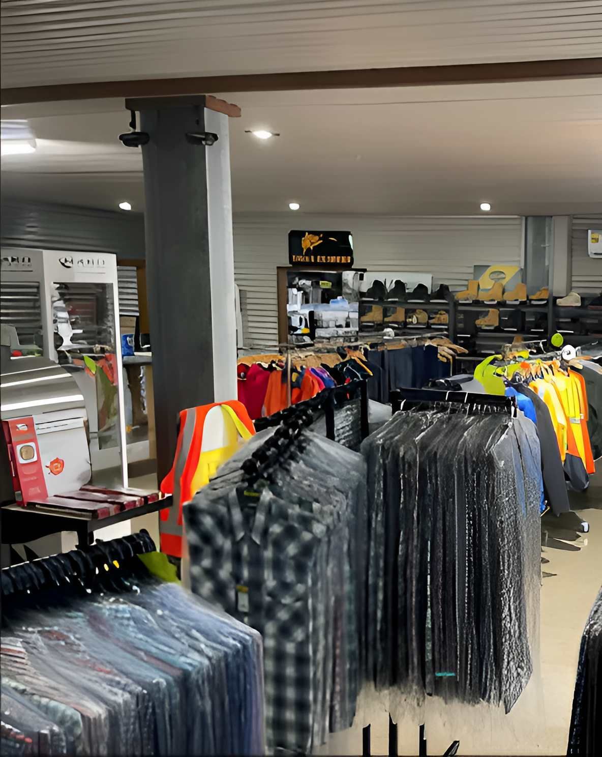 A Store Filled With Lots Of Clothes Hanging On Racks — Tableland Workwear In Tolga, QLD
