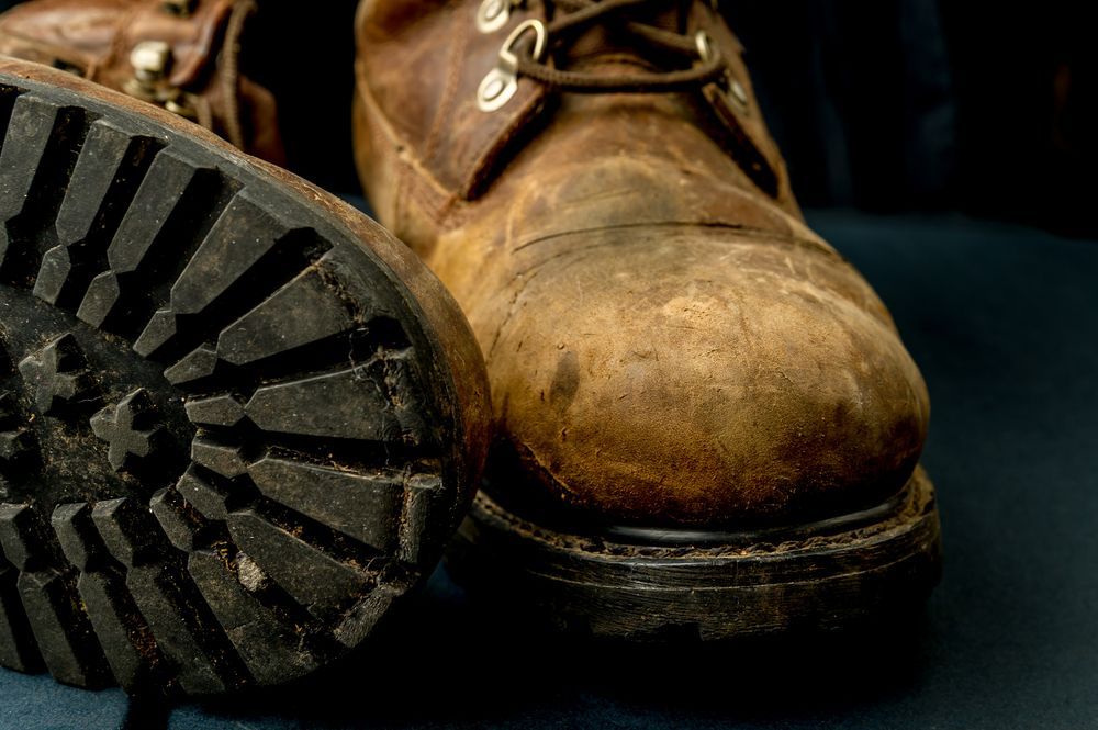 A Pair of Brown Boots Are Sitting on a Table — Tableland Workwear In Tolga, QLD