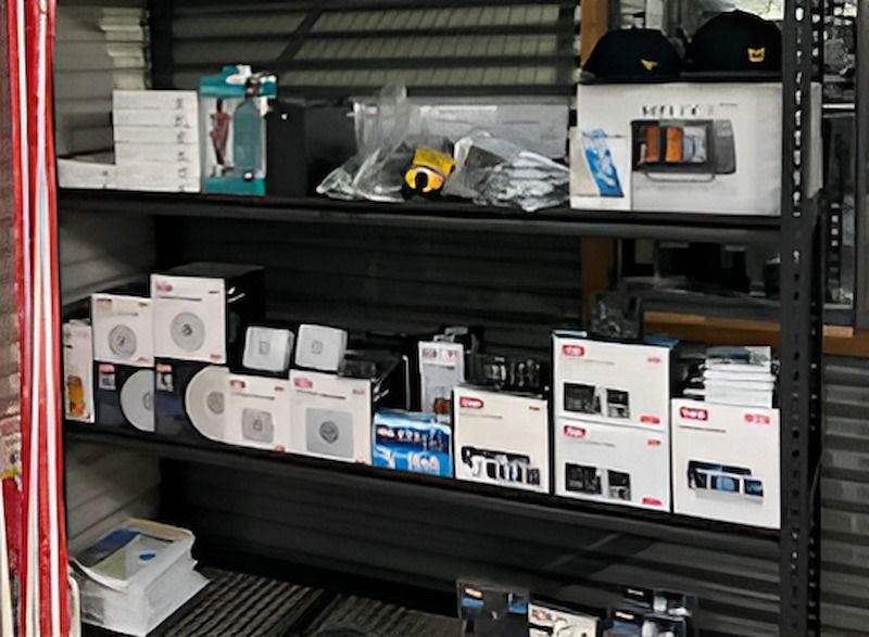 a Shelf Filled With Lots of Boxes — Tableland Workwear In Tolga, QLD