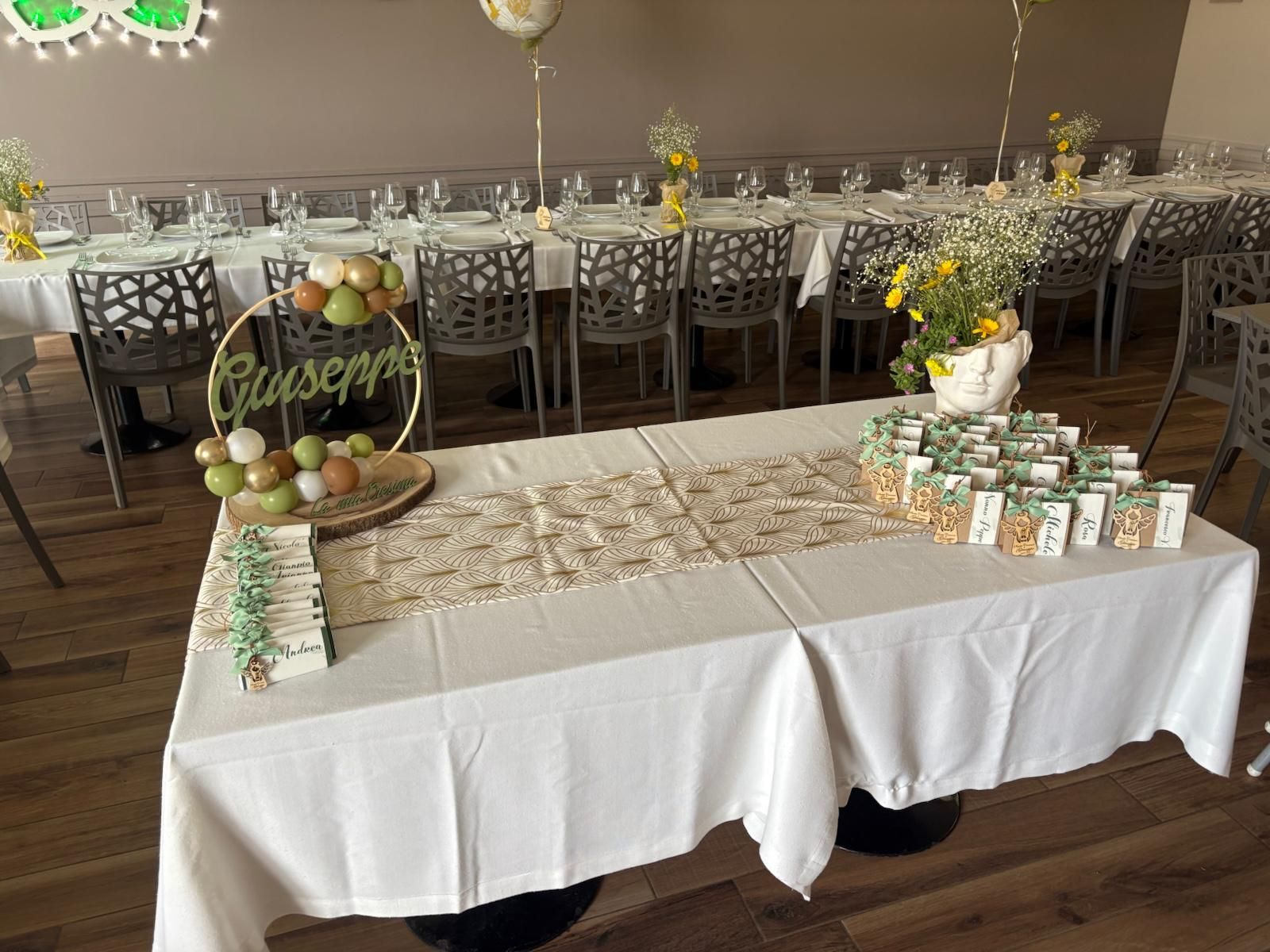 Un tavolo con una tovaglia bianca e un cartello con scritto Giuseppe sopra