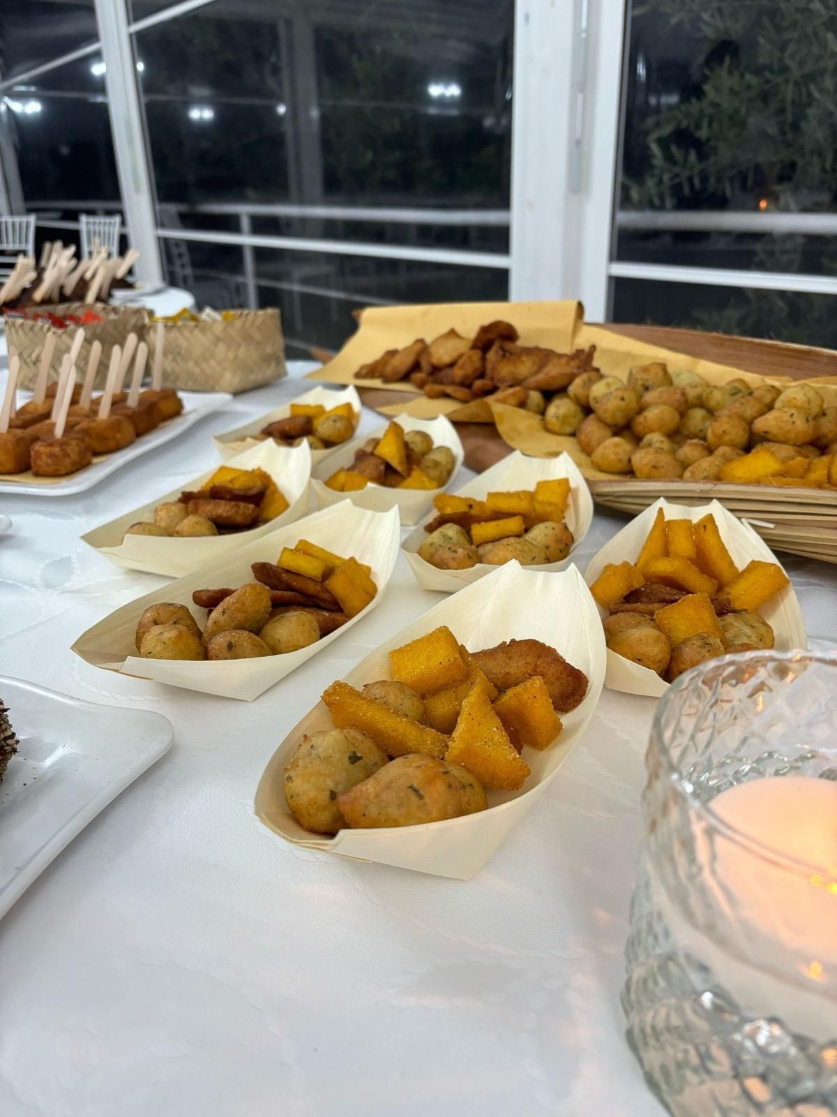 Un tavolo sormontato da piatti di cibo e una candela.