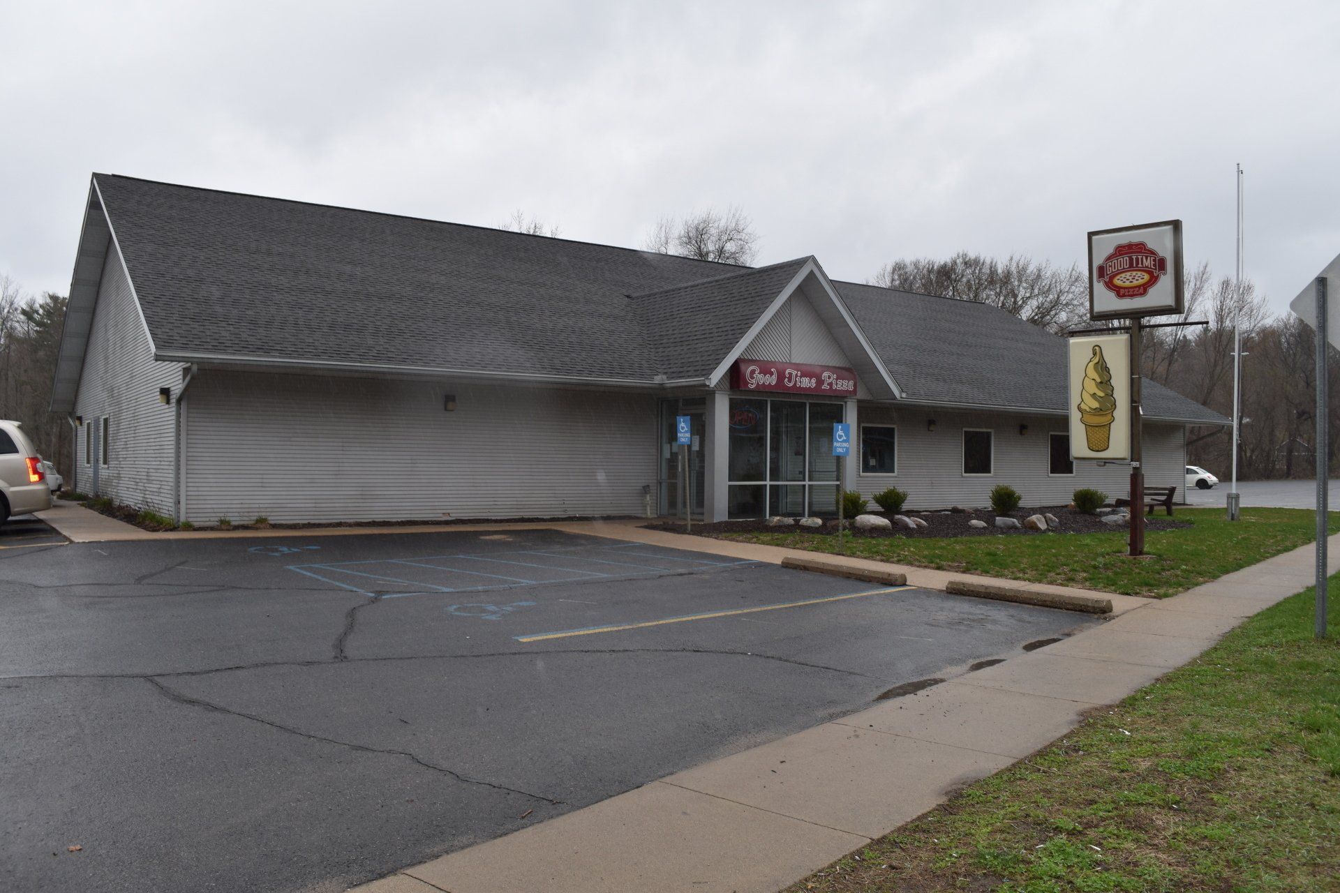 A white building with a sign that says ice cream on it.