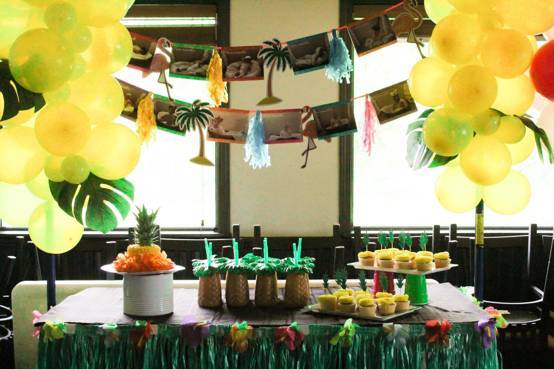 A table decorated with balloons and pineapples for a party