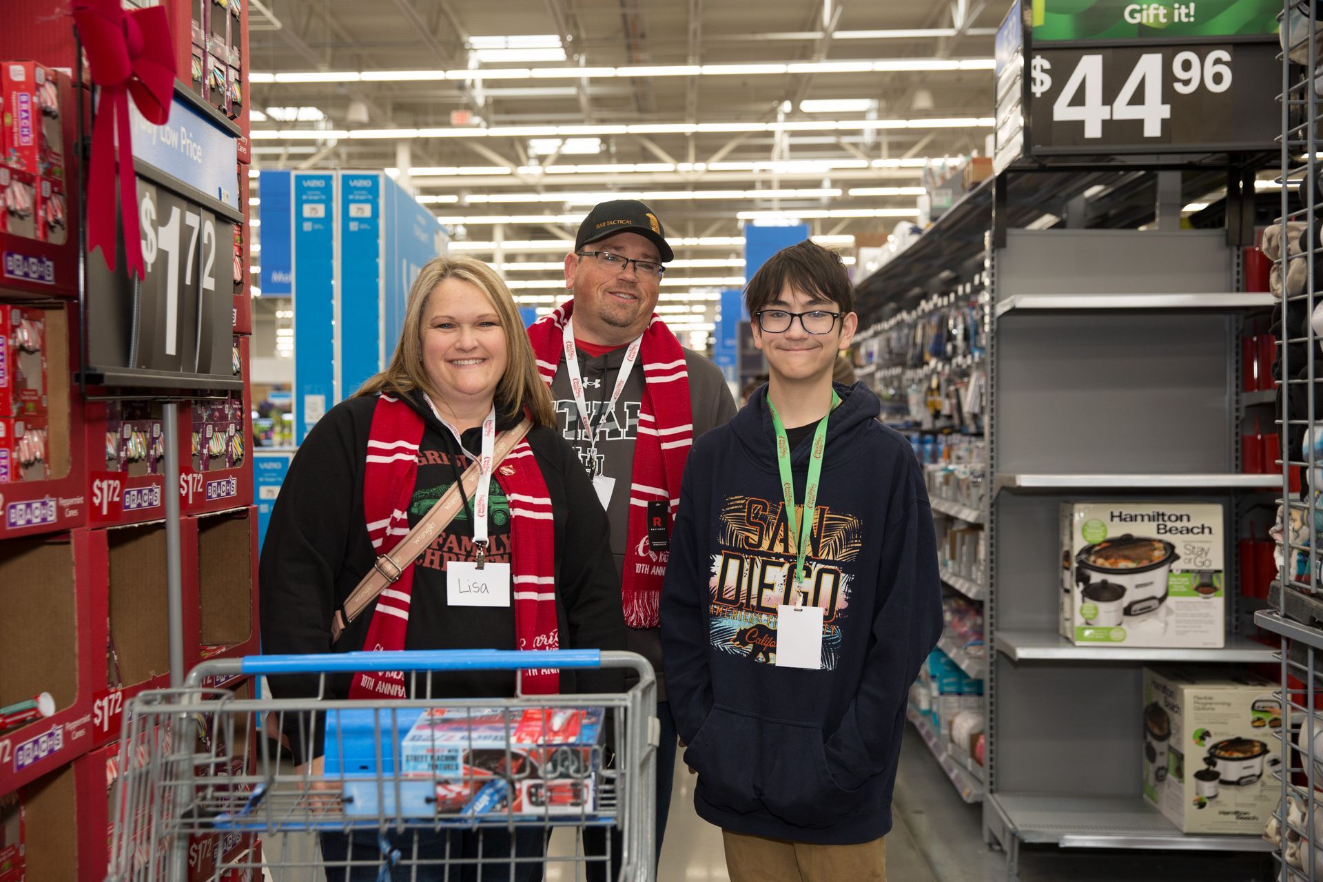 A family is shopping in a walmart and posing for a picture.