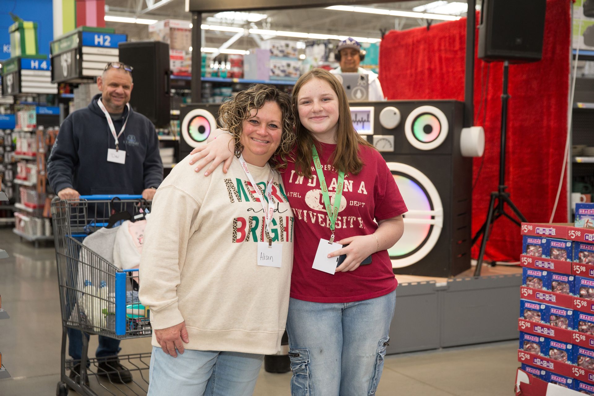 A woman and a girl are posing for a picture in a store.