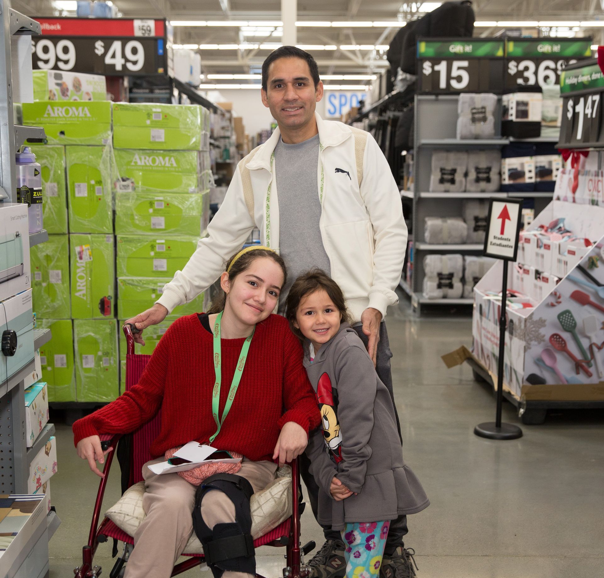 A woman in a wheelchair is posing for a picture with her family in a store