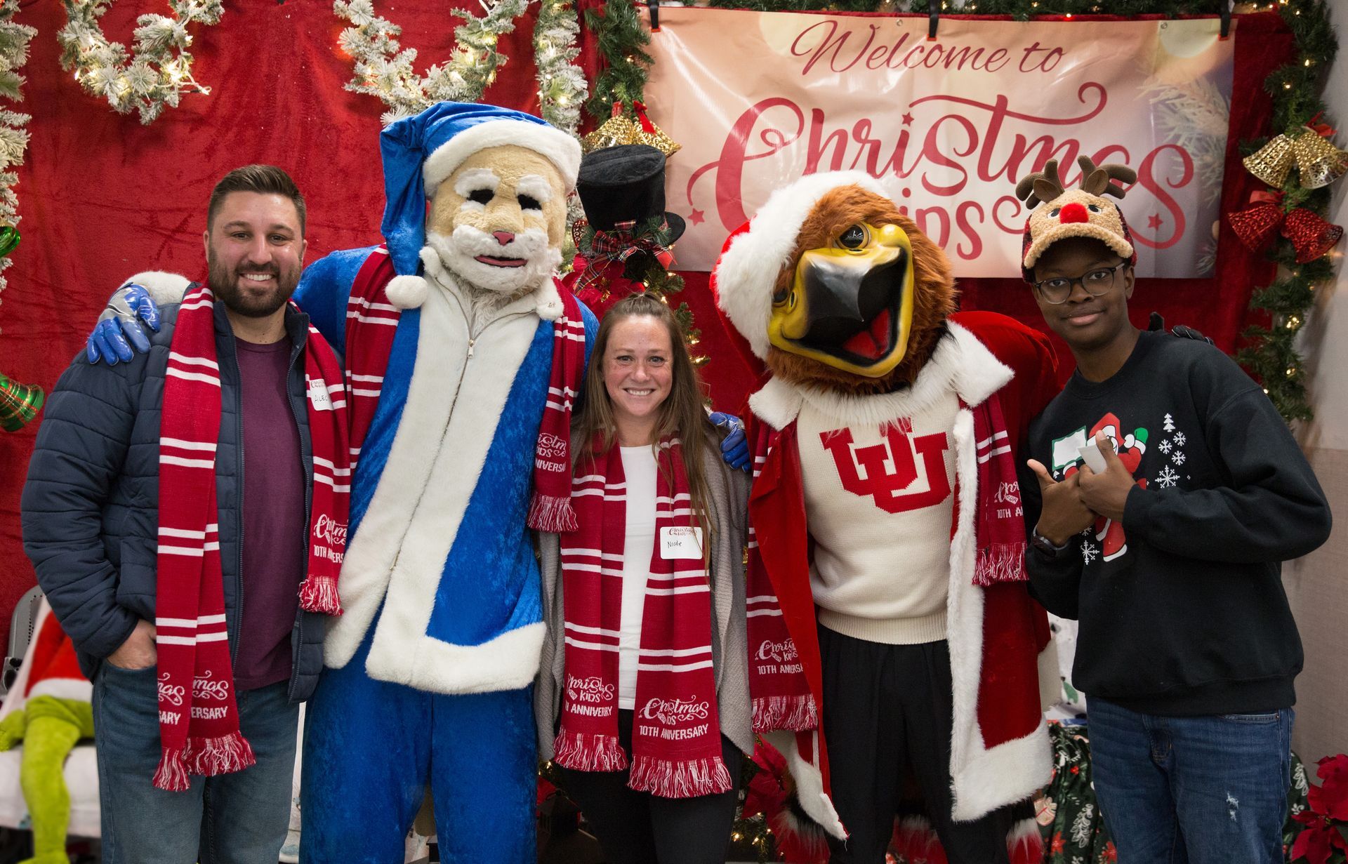 A group of people are posing for a picture with mascots.
