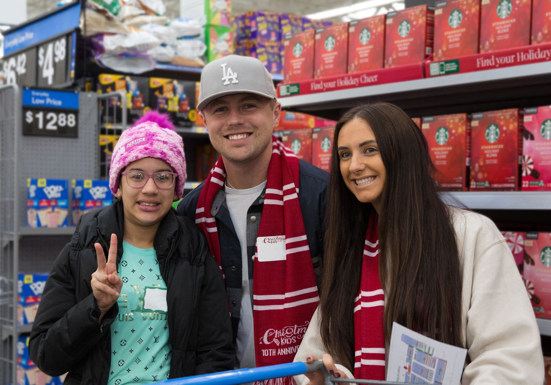A man and two women are standing next to each other in a store.