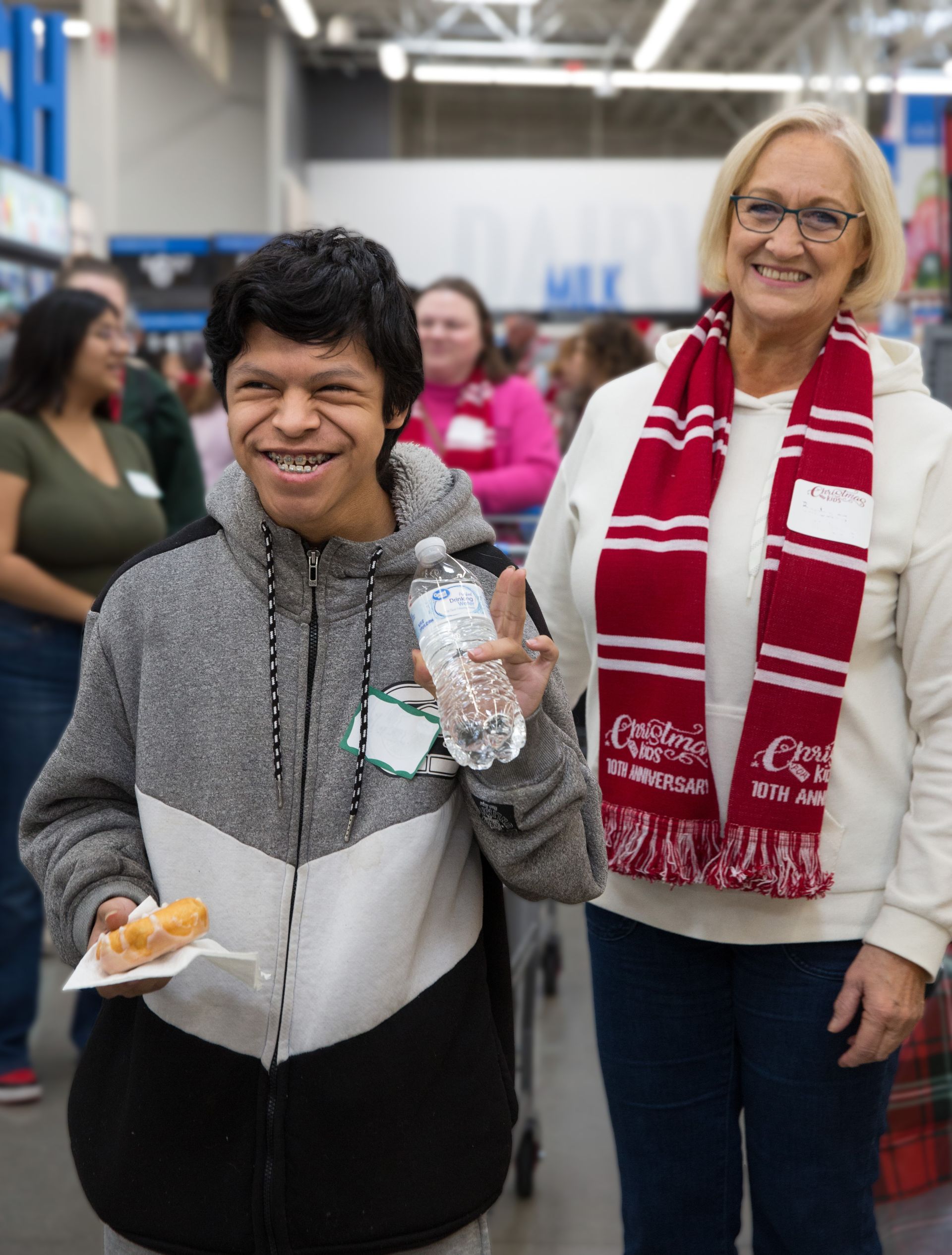 A man and a woman are standing next to each other in a store.