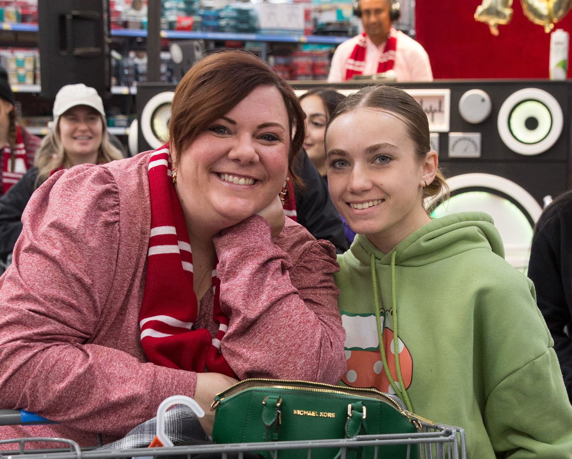 A woman and a girl are posing for a picture in a store.