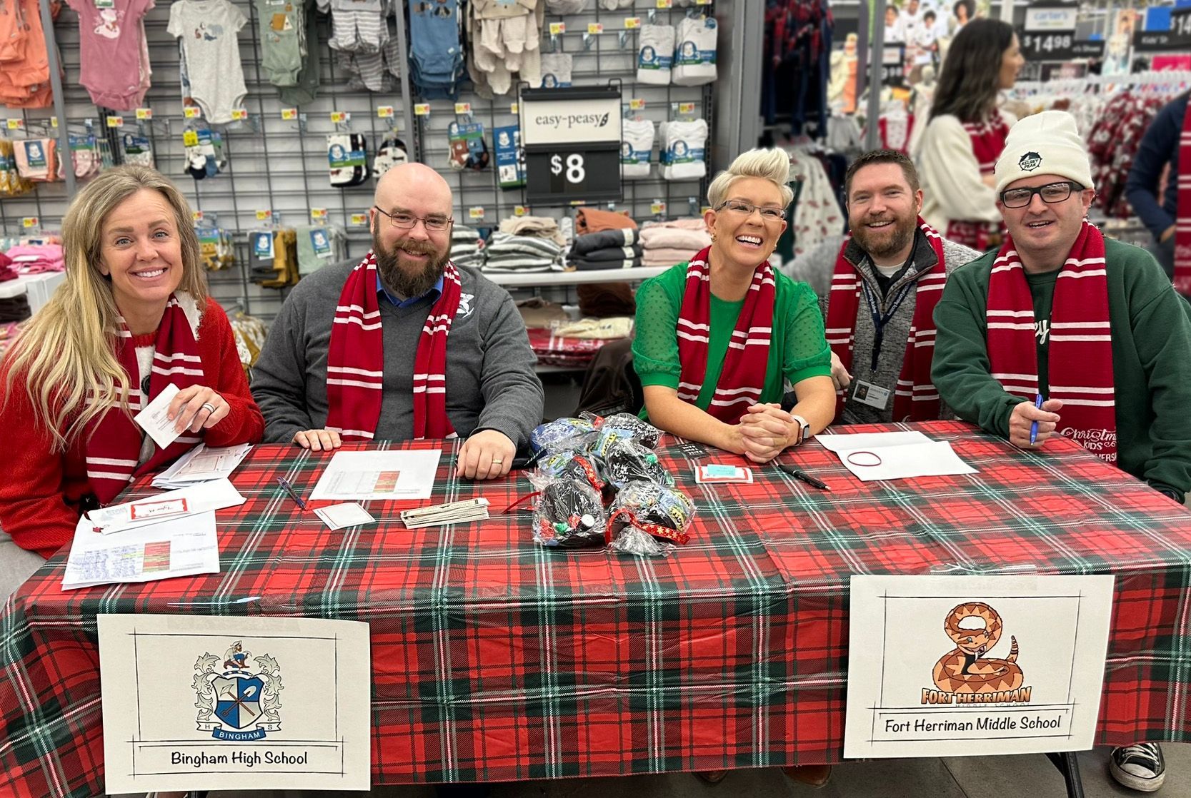 A group of people are sitting at a table in a store.