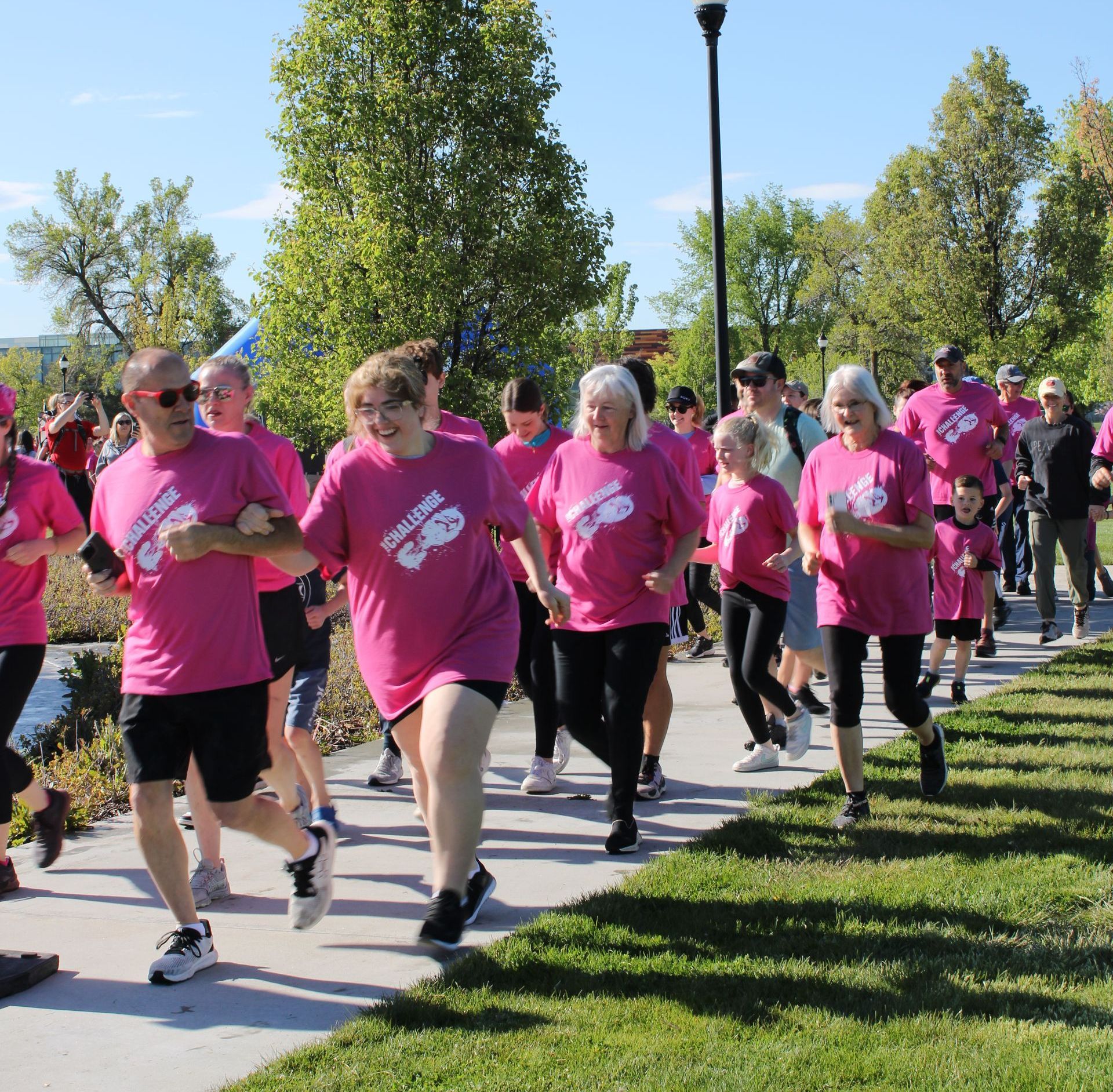 A group of people wearing pink shirts with the word challenge on them