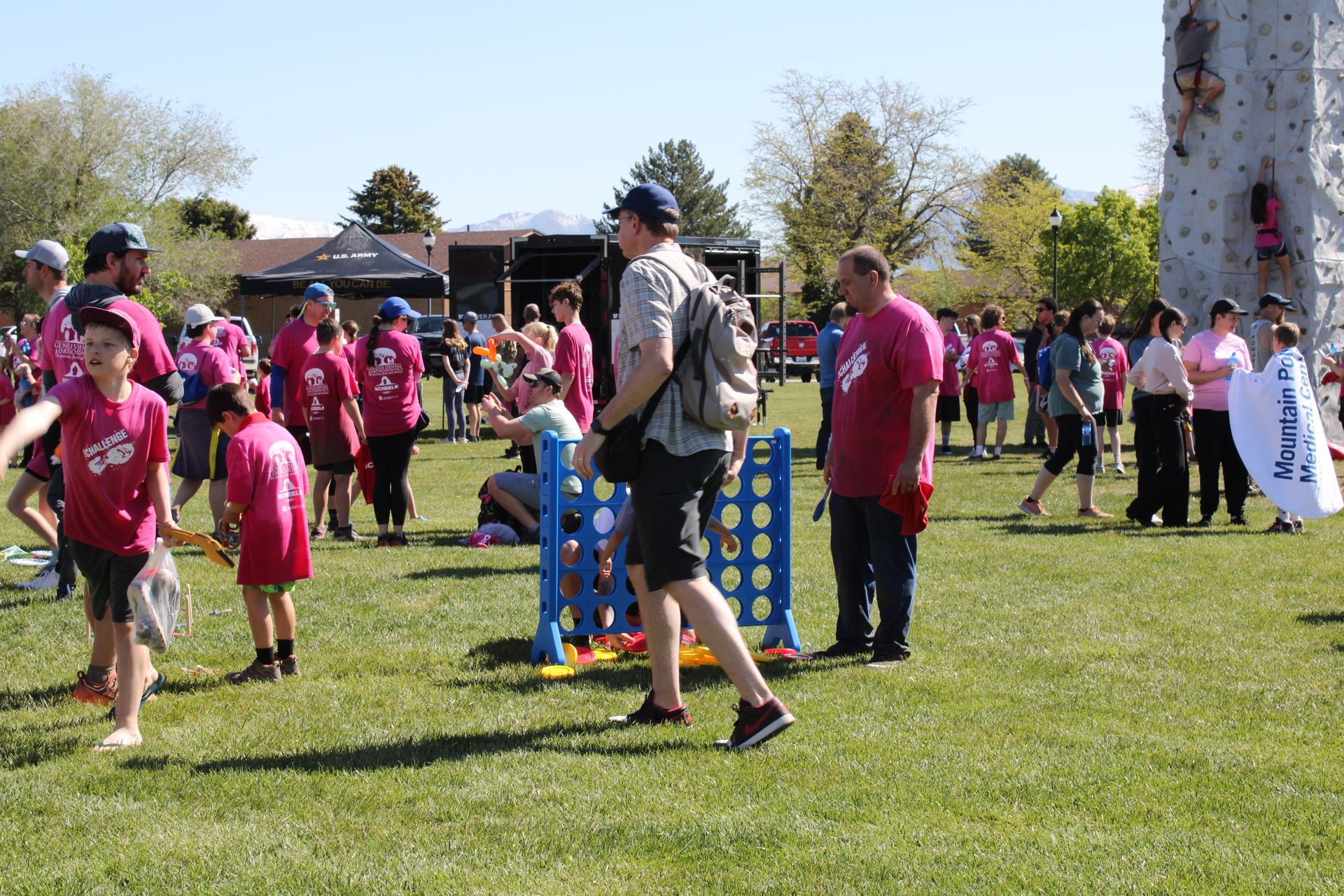 A group of people are playing a game of connect four in a park.