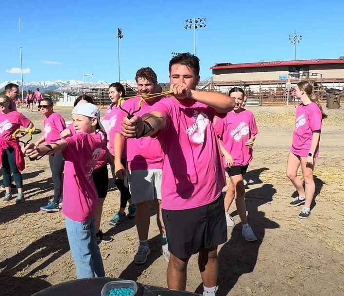 A group of people wearing pink shirts with the letter s on them