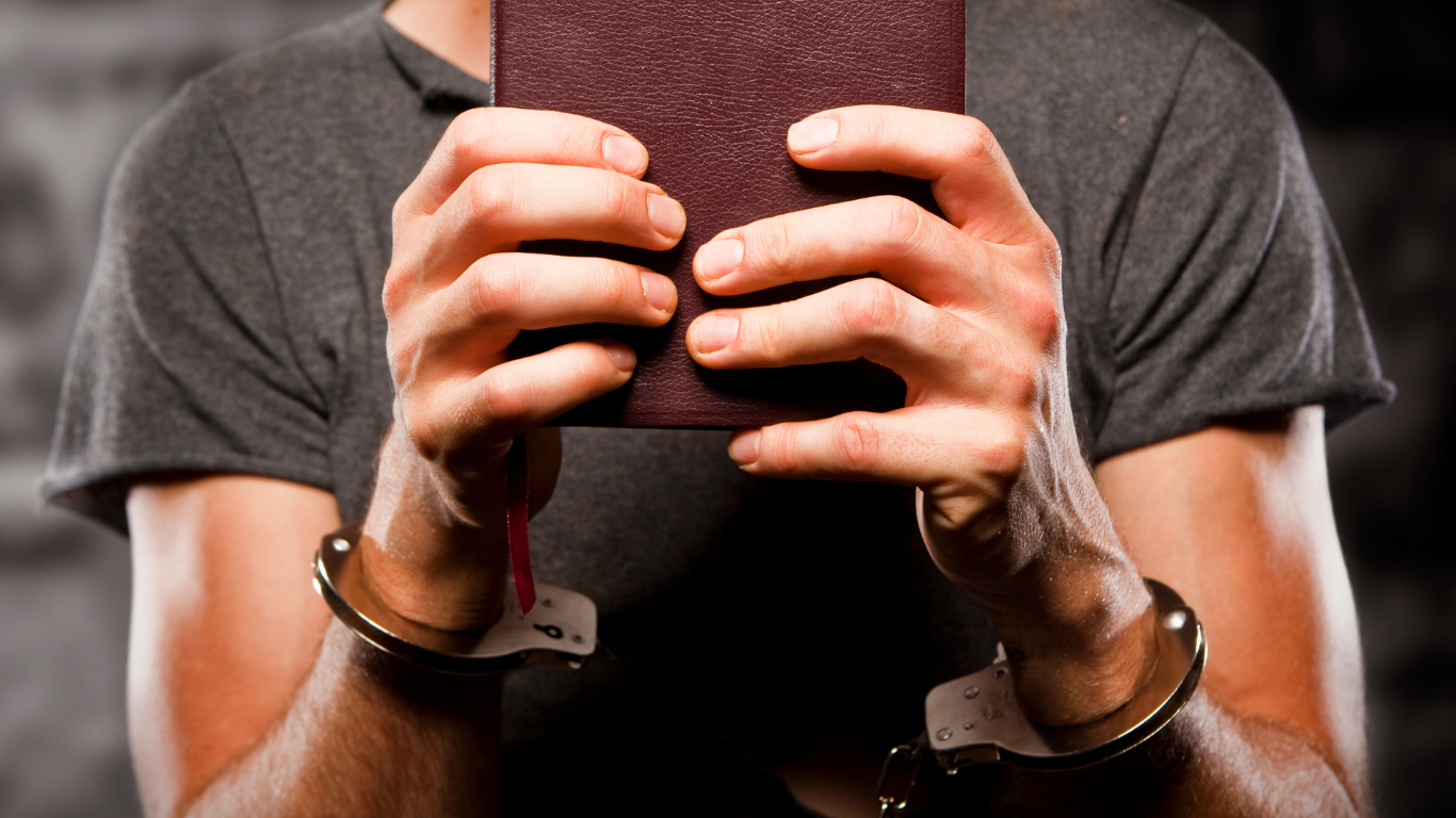 A holy bible is sitting on a stand in a church.