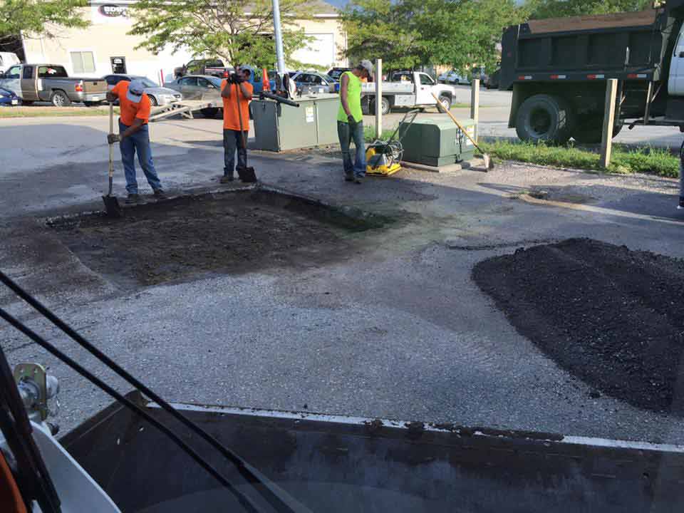 Paving Road Contractors — Professionals Repairing a Road in Omaha, NE