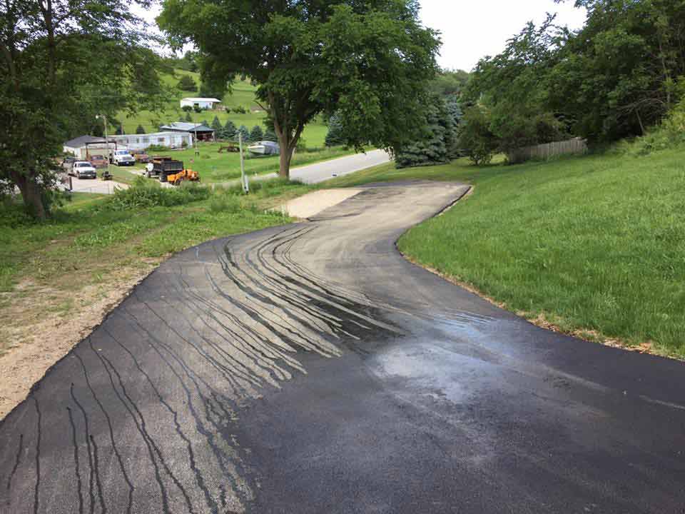 Asphalt Seal Coats Service— Asphalted Downhill Road in Omaha, NE