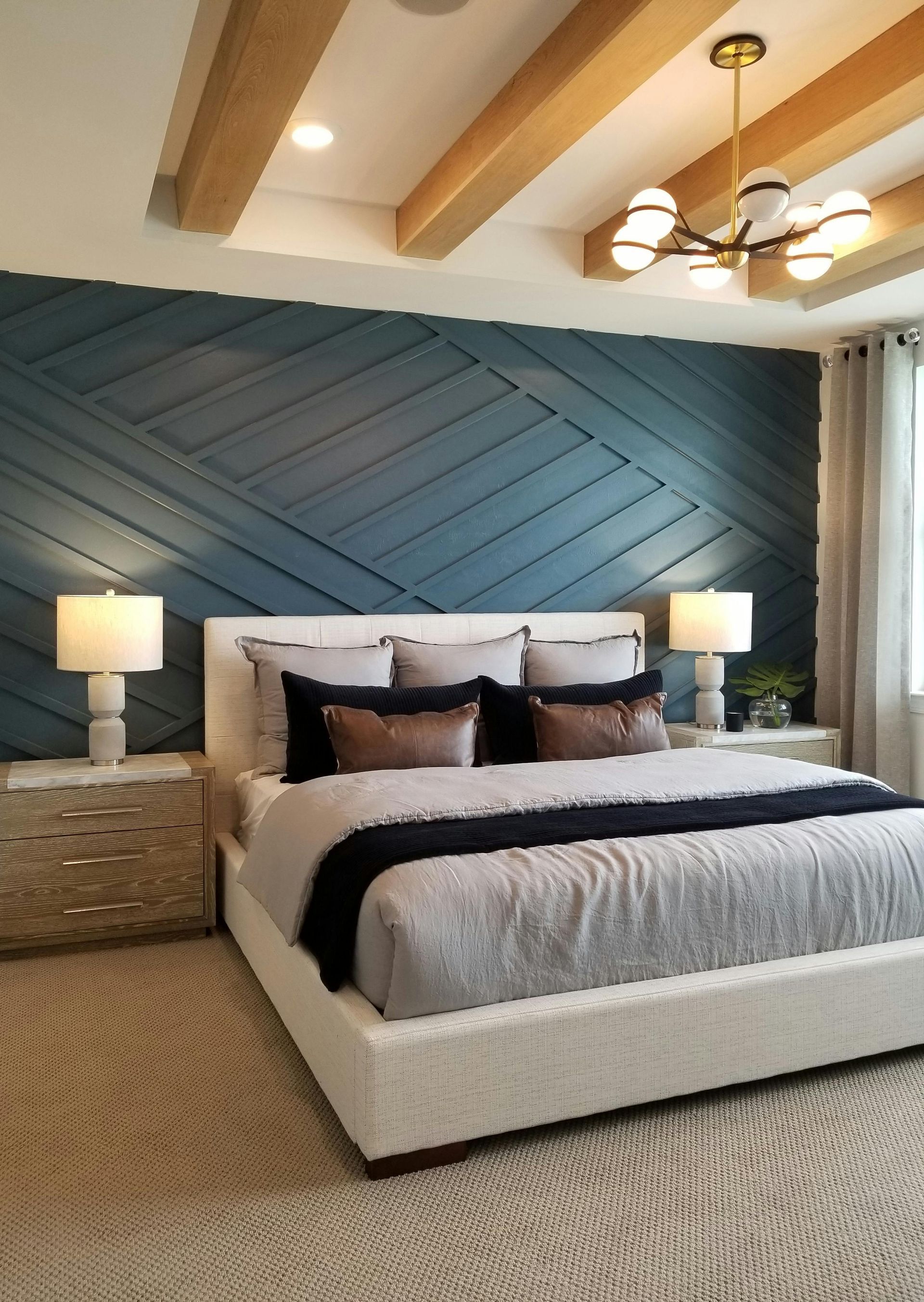 A bedroom with a large bed and a blue wall.