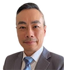 A man in a suit and tie is smiling for the camera.