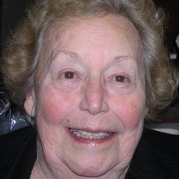 A close up of an elderly woman 's face smiling.