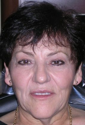 A close up of a woman 's face with a necklace around her neck.