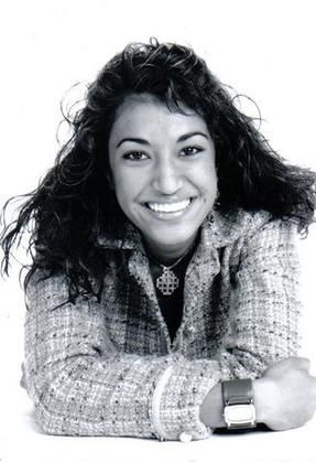 A woman is smiling in a black and white photo