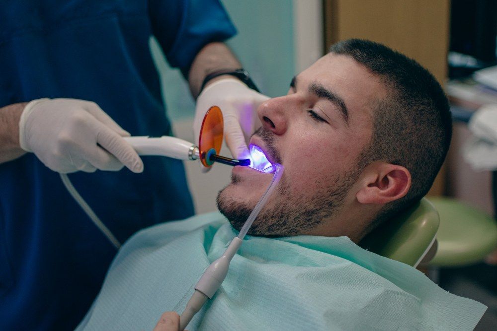Dental bonding curing light applied during treatment