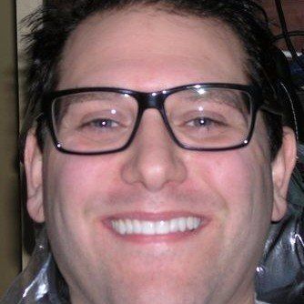 A close up of a man wearing glasses and smiling